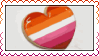 Animation of someone icing a heart-shaped cookie with the lesbian pride flag colors
